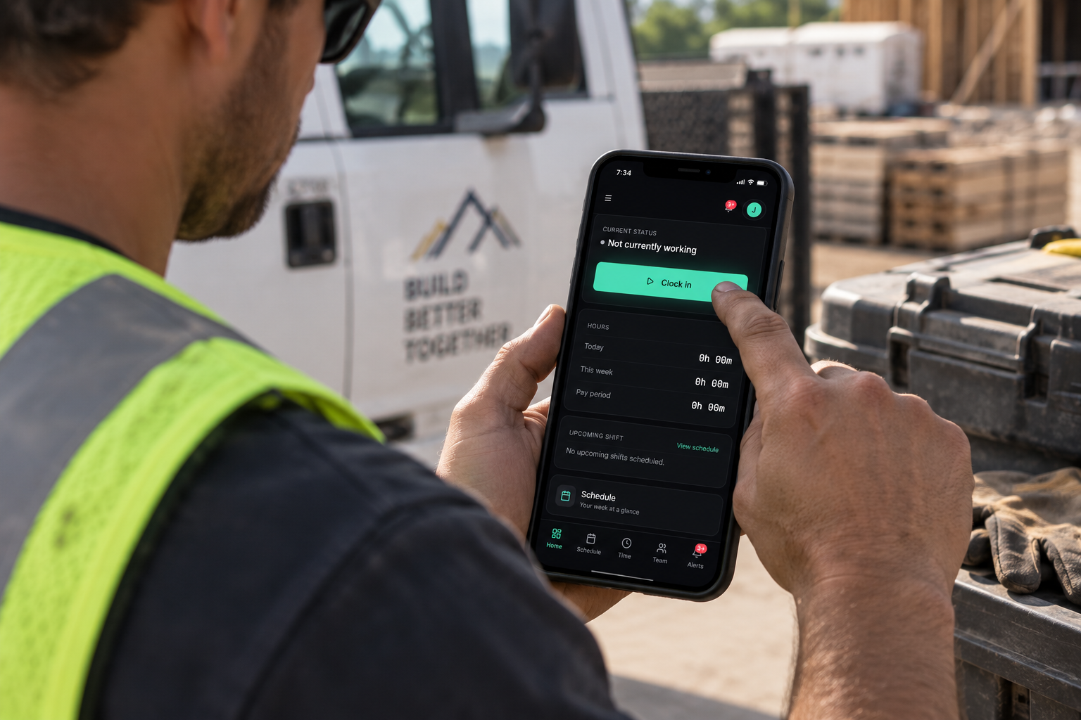 Worker in a safety vest clocking in on the WorkTalora app on his phone at a job site